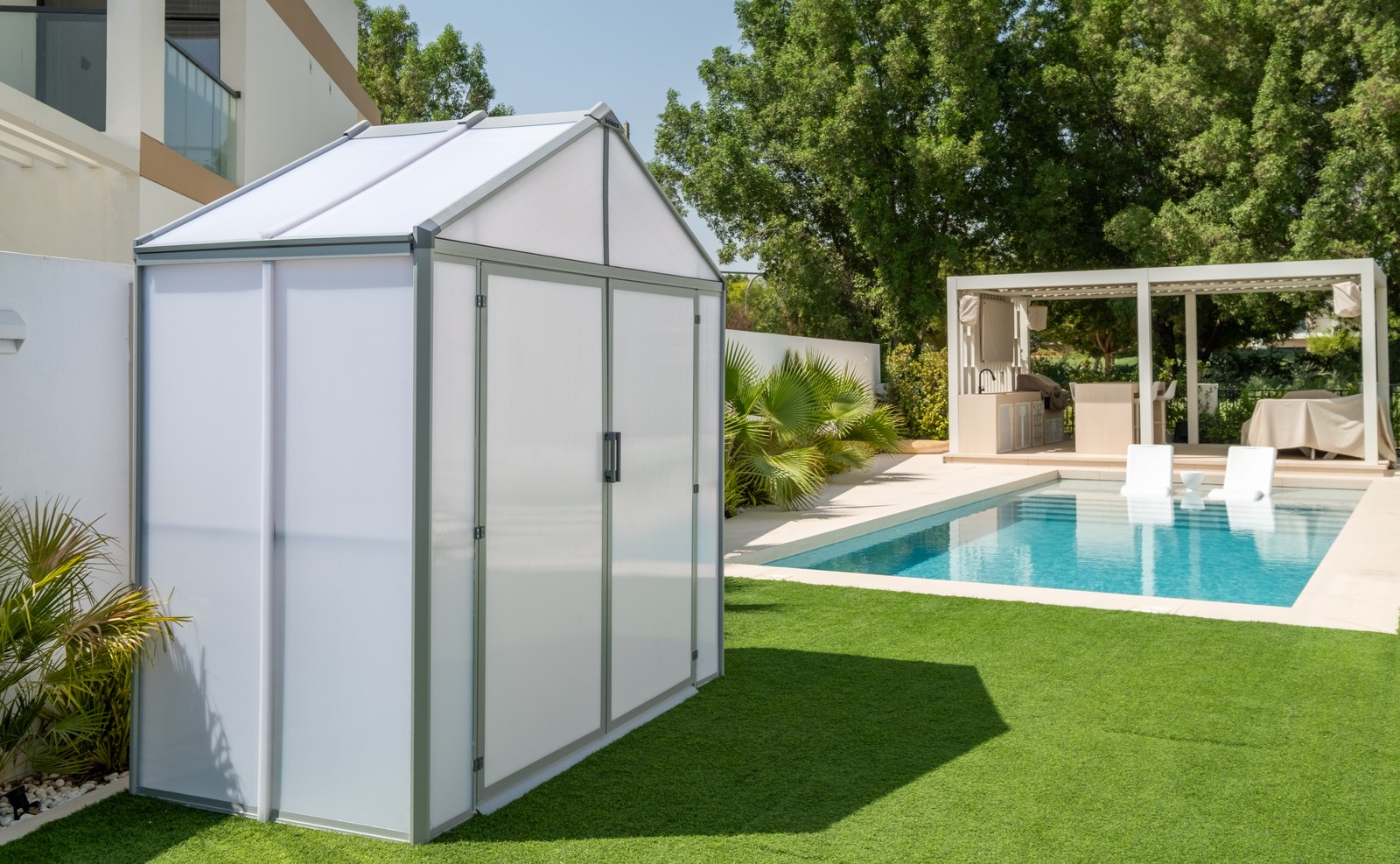 DOMER garden shed beside a swimming pool